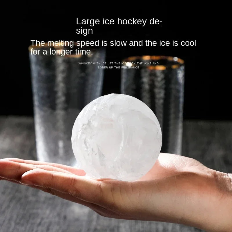 A big transparent ice ball in the palm of your hand